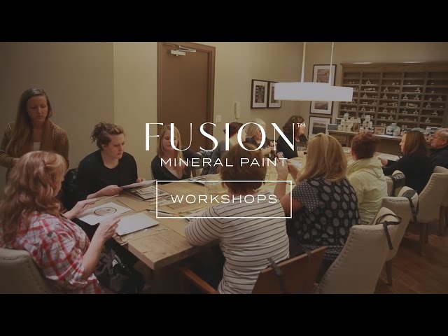 A group of people painting in a workshop 