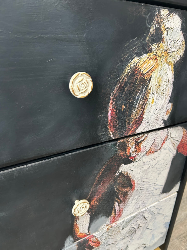 Close-up of hardware on a black hand-painted dresser, showing artisanal furniture detailing and custom finish