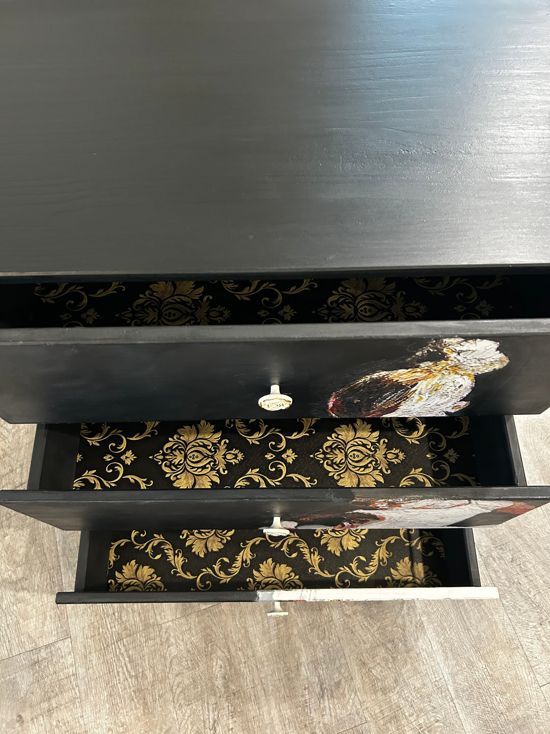 Custom drawer interiors with decorative pattern inside a hand-painted black dresser, highlighting unexpected interior design details
