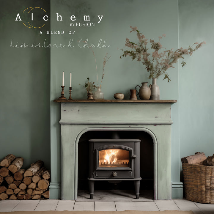 a fireplace painted in a light green with a fire going