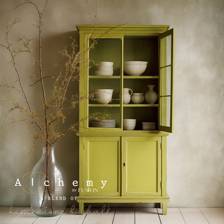 a hutch painted int willow green with white dishes