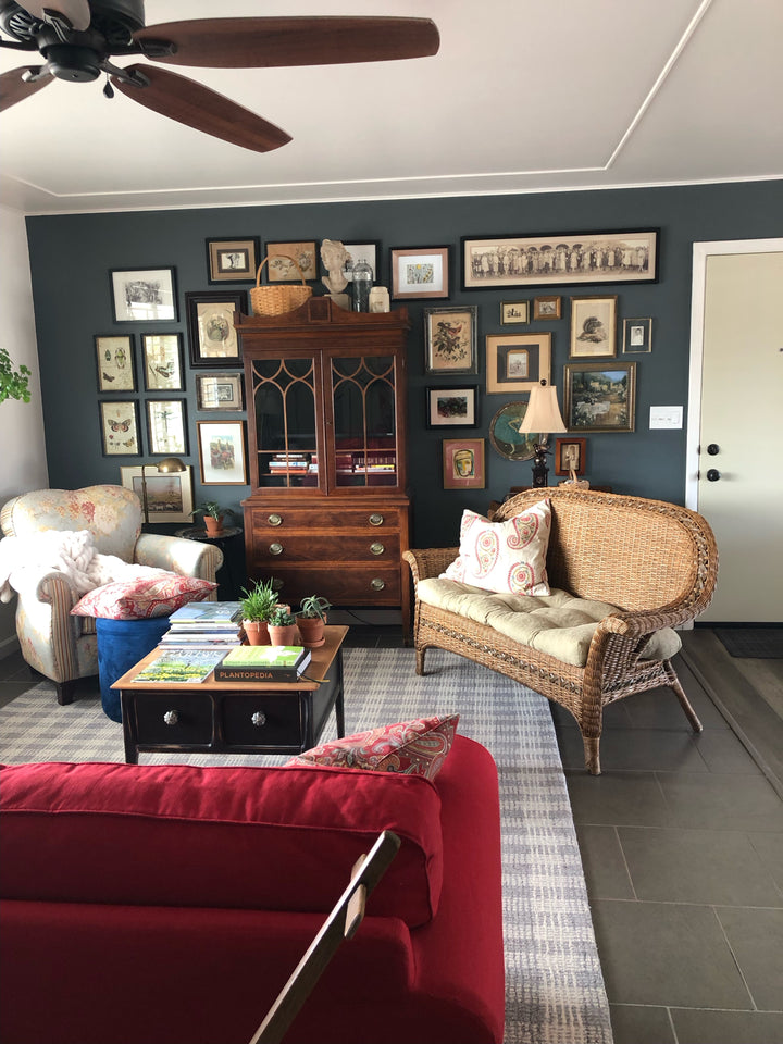 Moody living room interior with dark walls and vintage furniture, serving as inspiration for a piece currently in the studio
