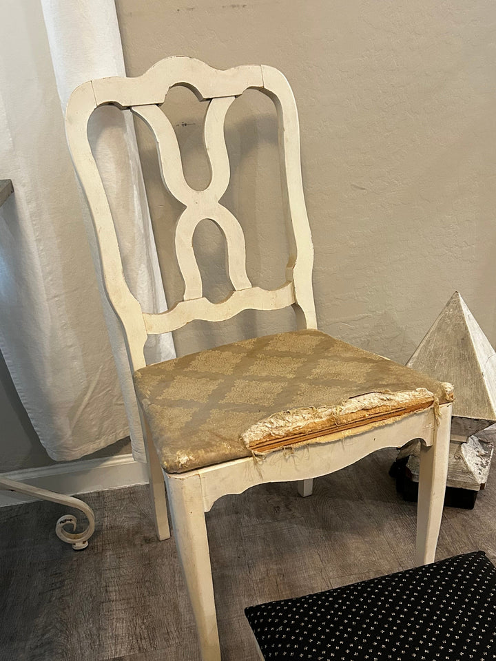 Classic accent chair in progress, showing original frame before being painted black and reupholstered with graphic polka dot fabric