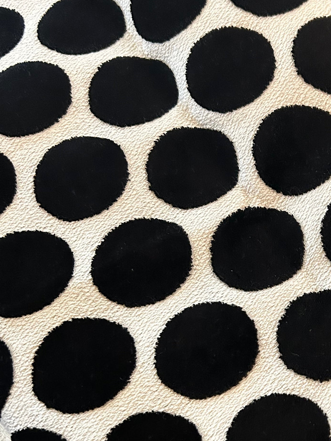 Graphic black and ivory polka dot upholstery fabric selected for a one-of-a-kind black accent chair