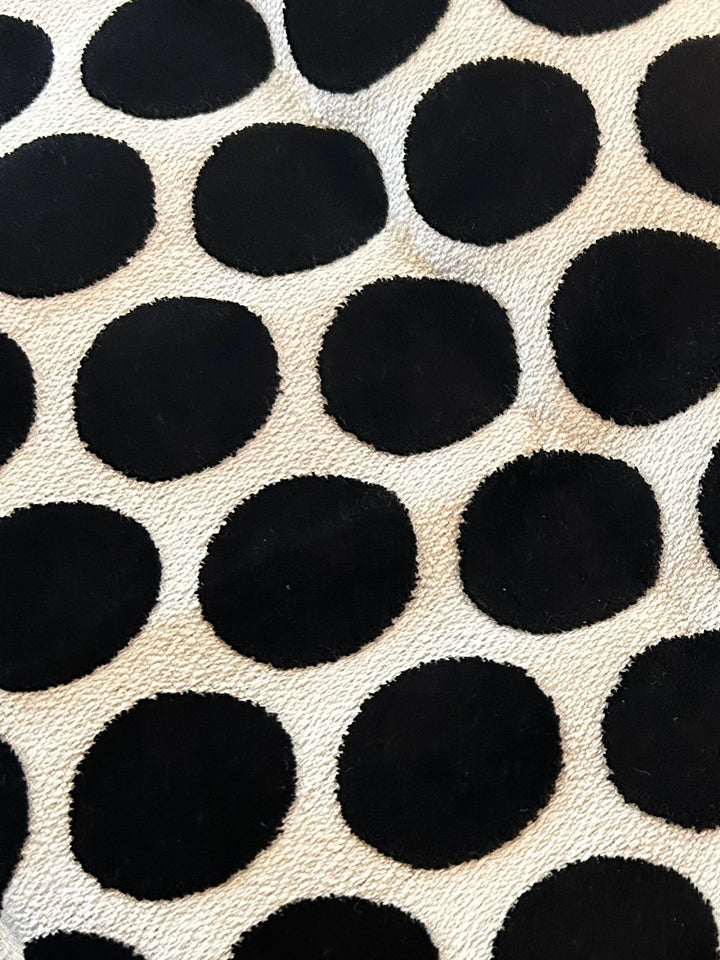 Graphic black and ivory polka dot upholstery fabric selected for a one-of-a-kind black accent chair