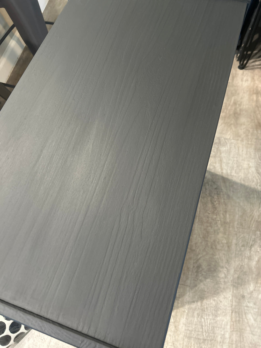 Smooth black painted dresser top with low-sheen finish, highlighting professional furniture painting craftsmanship