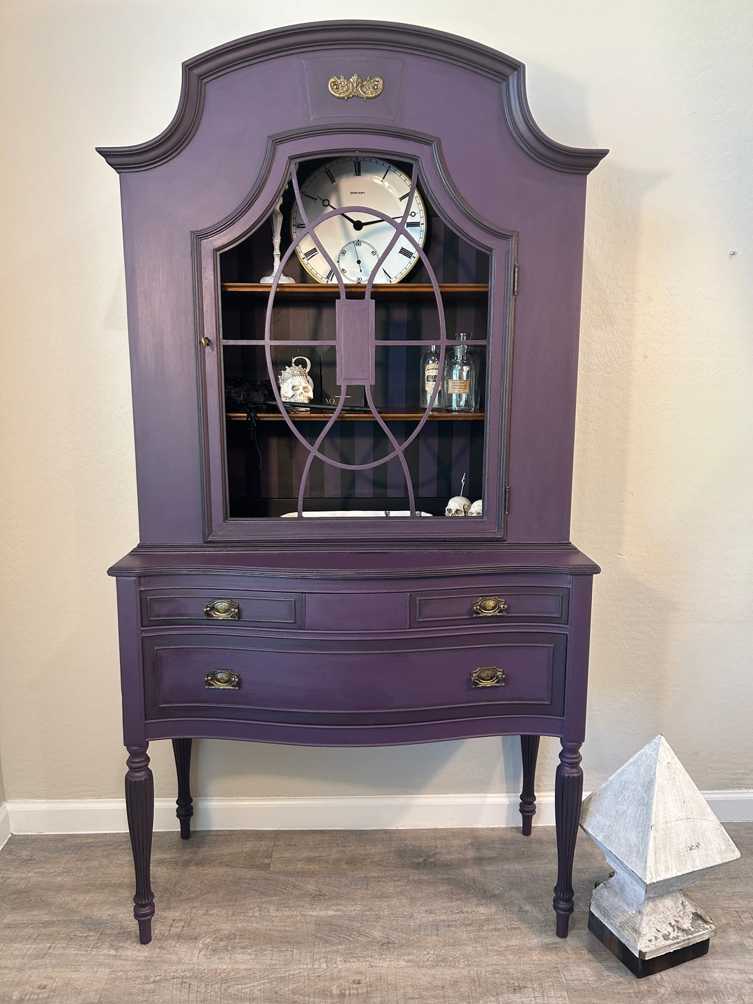 Moody statement hutch styled with decor accents, designed to anchor a room as functional art